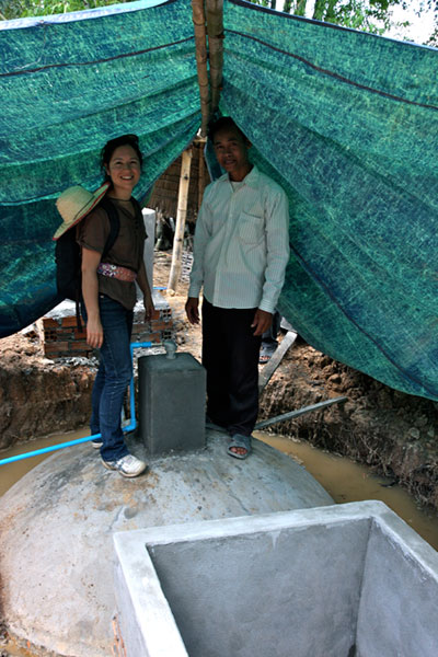 Jasmine atop a biodigester with a local user
